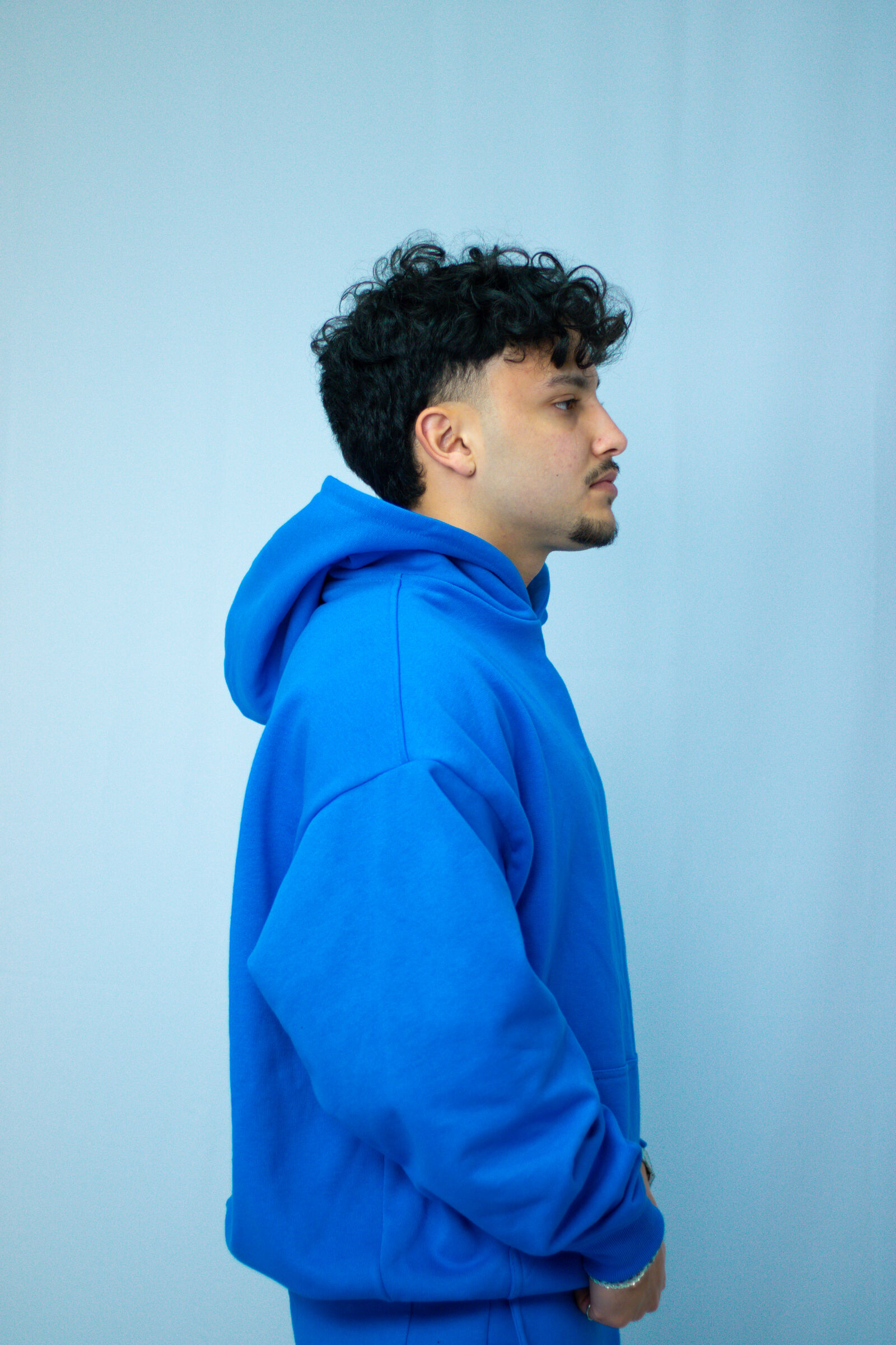 Model in royal blue branded tracksuit set under studio lights